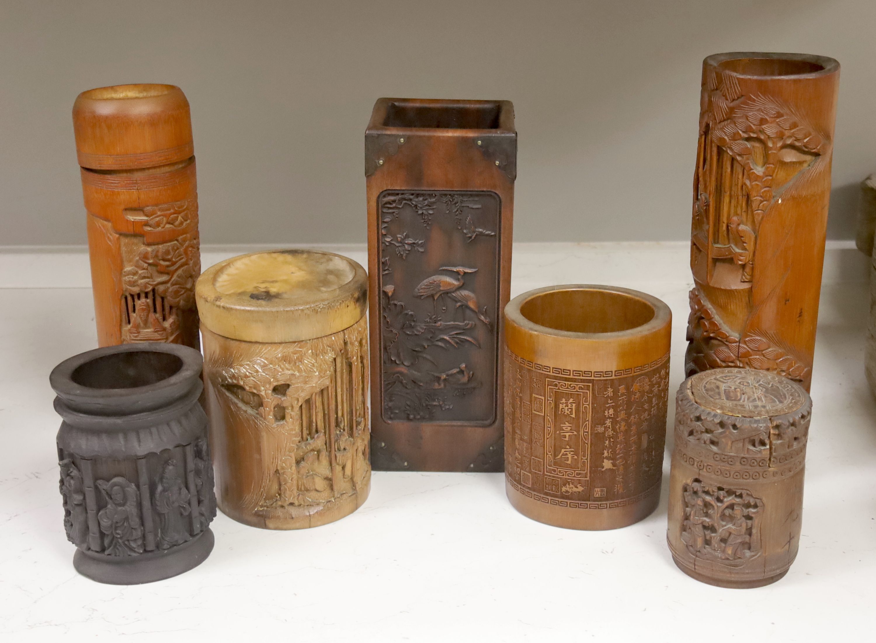 Three Chinese carved bamboo tea caddies and four carved bamboo brush pots